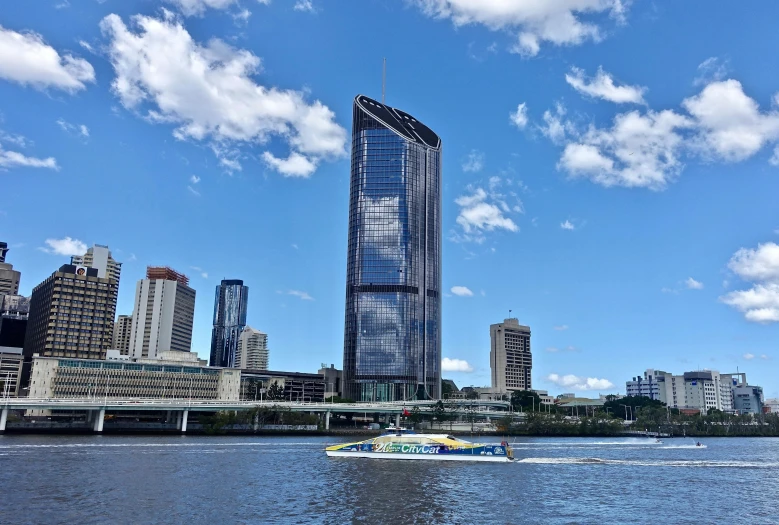 a boat traveling down a river next to tall buildings, on a hot australian day, colossal tower, bling, thumbnail