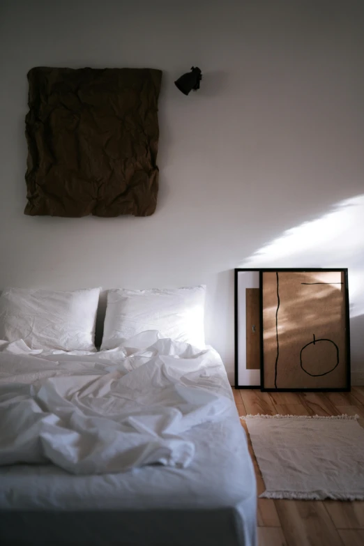 a white bed sitting on top of a wooden floor, poster art, unsplash, light and space, late afternoon sun, ocher, ignant, framed in image