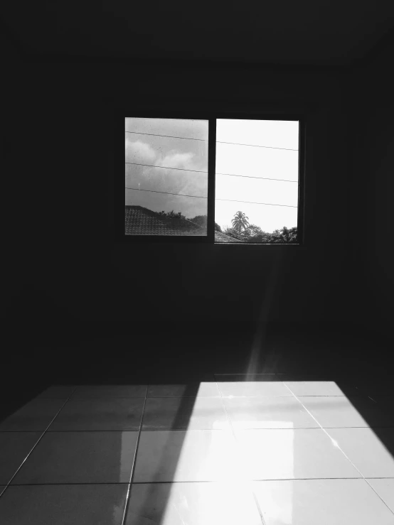 a black and white photo of an empty room, inspired by Max Dupain, unsplash, light and space, holga, sun down, window ( rain ), color photograph