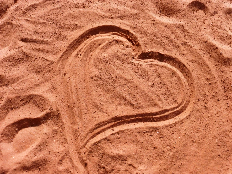 a heart drawn in the sand on a beach, by Valentine Hugo, trending on pixabay, symbolism, terracotta, in a dusty red desert, recipe, 1790