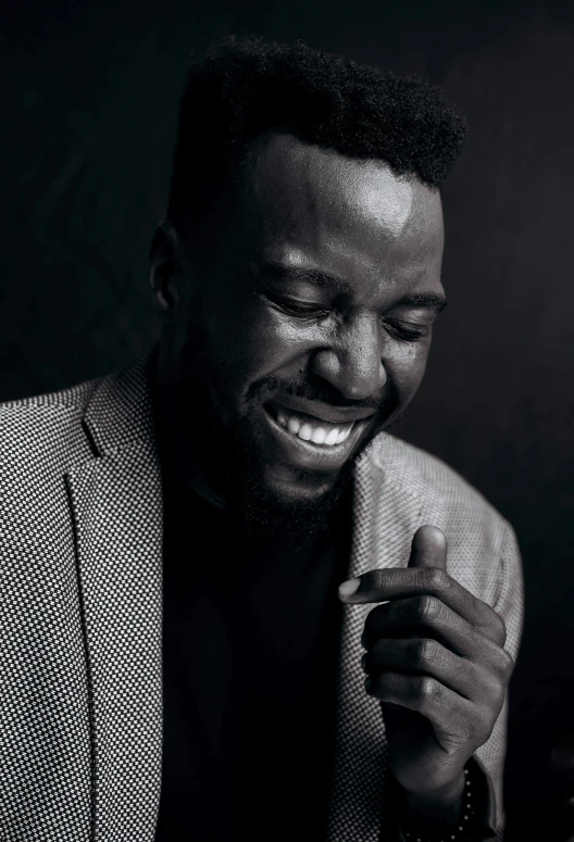 a black and white photo of a man laughing, an album cover, inspired by David Bailly, pexels contest winner, les nabis, godwin akpan, actor, portrait of hollow knight, lights on