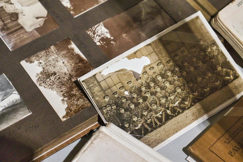 a collection of old photographs sitting on top of a table, ww1, brown, illustration »