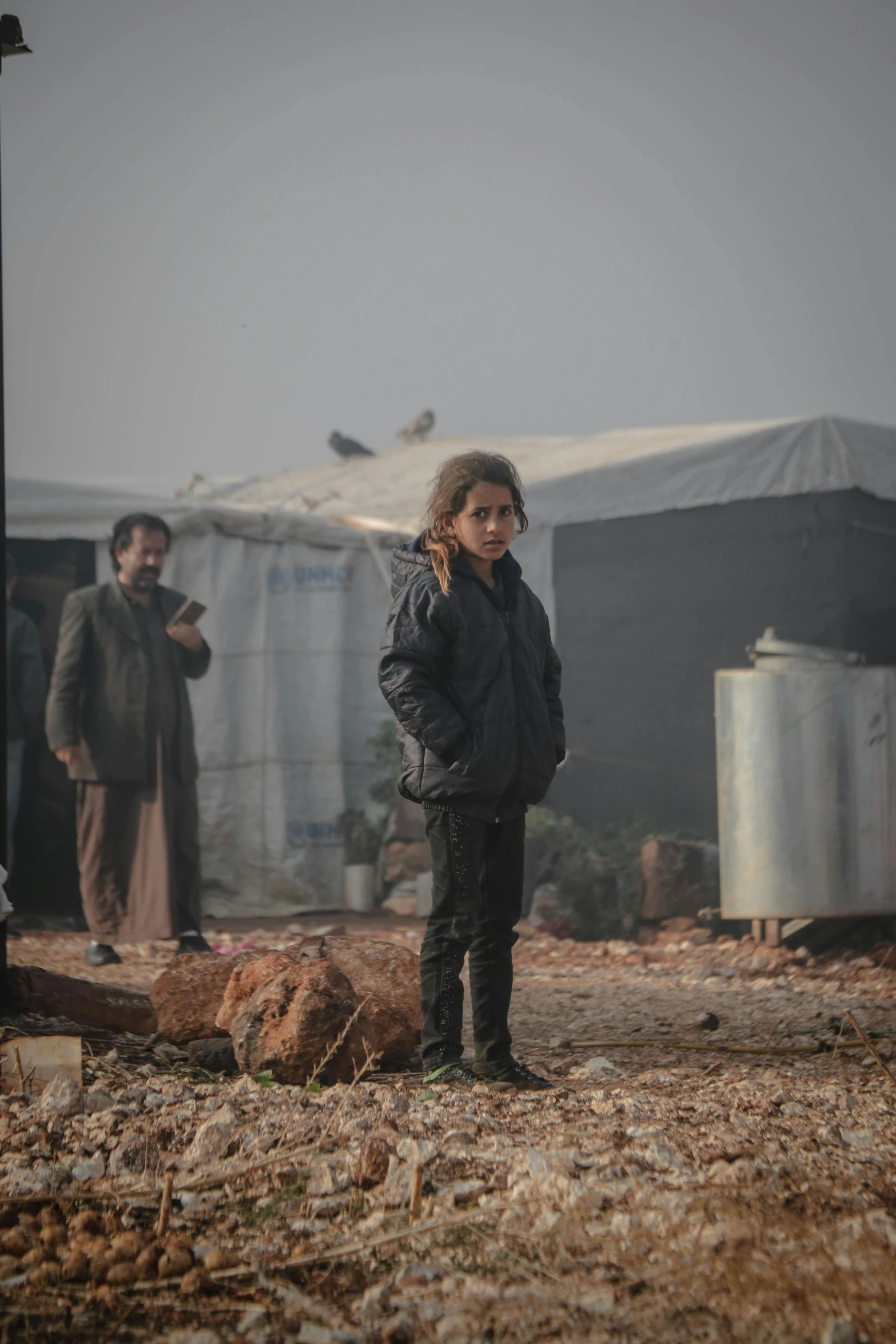 a group of people standing on top of a dirt field, dafne keen, real life photo of a syrian man, january 20th, promo image