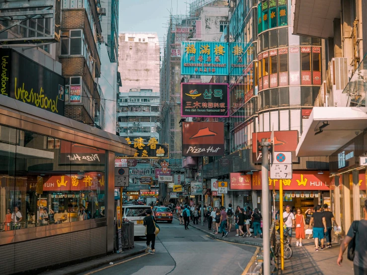 a group of people walking down a street next to tall buildings, a photo, pexels contest winner, hyperrealism, chungking express color palette, food stalls, glowing street signs, where a large