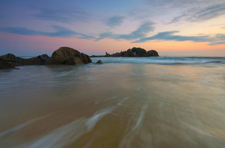 a beach that has some rocks in the water, unsplash contest winner, soft glow, sri lankan landscape, multicoloured, today\'s featured photograph 4k