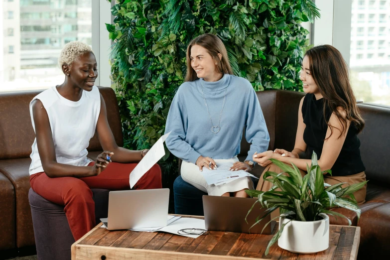 three women sitting on a couch talking to each other, trending on pexels, hurufiyya, greenery, office background, brown, thumbnail