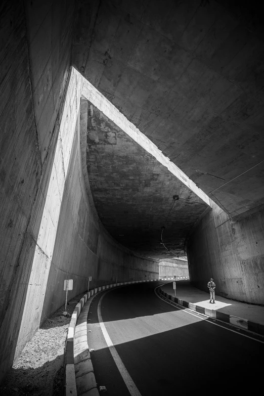 a black and white photo of a tunnel, by Tadao Ando, unsplash contest winner, conceptual art, lonely rider, corner, tsutomu kitazawa, giant tomb structures