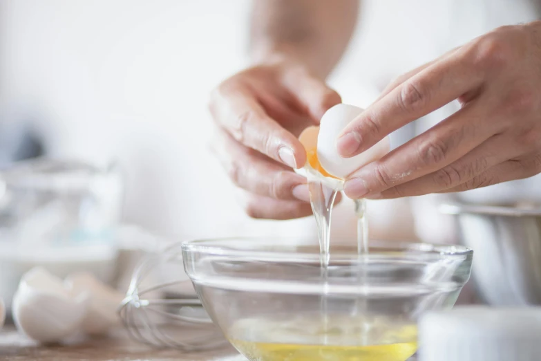 a person squeezing an egg into a bowl, by Elizabeth Durack, trending on pexels, skincare, baking artwork, james webb, filling with water