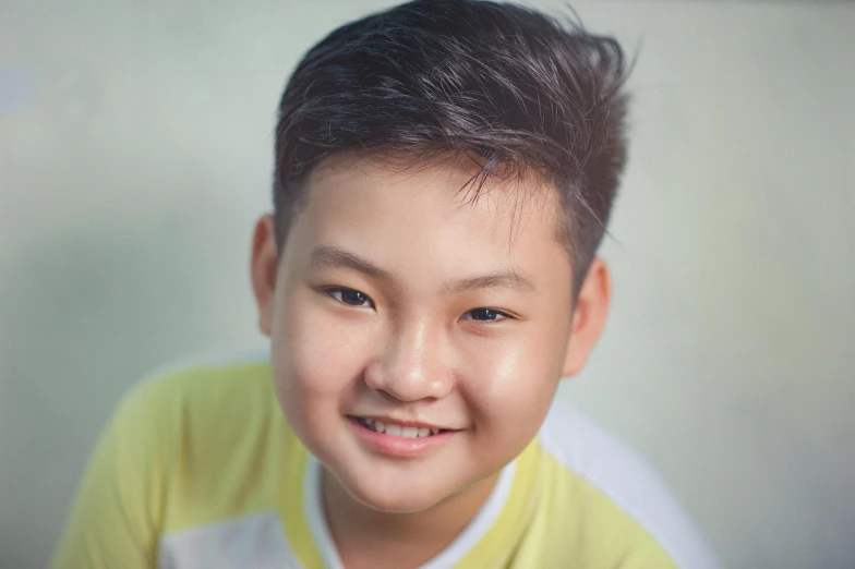 a young boy in a yellow shirt smiles at the camera, a picture, inspired by Yeong-Hao Han, pexels contest winner, headshot profile picture, aged 13, avatar image, close - up studio photo