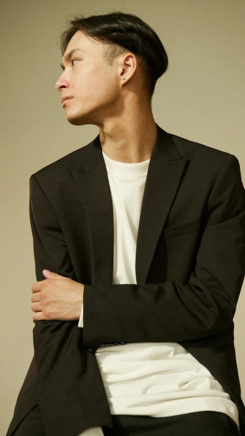 a man in a black jacket and white shirt, inspired by Tadashi Nakayama, unsplash, low details and clean lines, modeled, black matte finish, from side