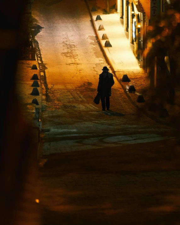 a person walking down a street at night, by Tamas Galambos, pexels contest winner, happening, in the morning light, harsh