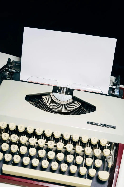 a close up of a typewriter on a desk, an album cover, no - text no - logo, 1960s color photograph, 1999 photograph, blank