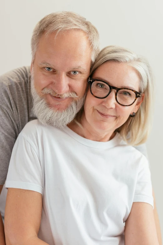 a man and a woman posing for a picture, white glasses, some grey hair, scandinavian, medical image