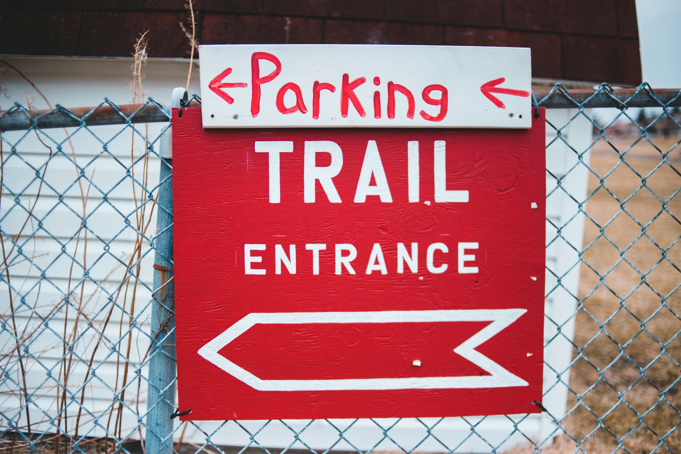 a red and white sign on a chain link fence, pexels, pathway, off-roading, tournament, square