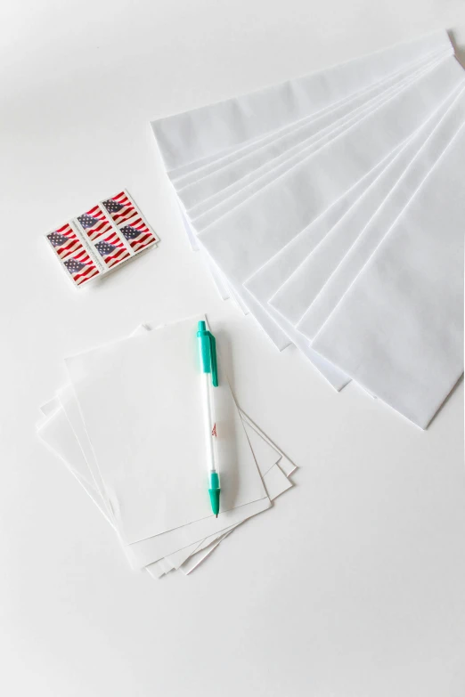 a pile of white envelopes sitting on top of a table, american flags, sharpie, official product photo, white splendid fabric