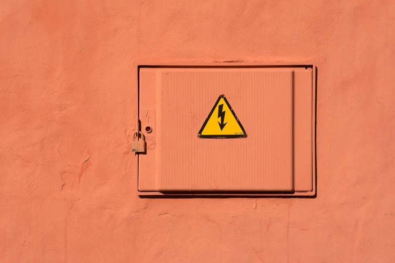 a sign that is on the side of a building, inspired by Wes Anderson, trending on pexels, postminimalism, high voltage warning sign, square, an abstract, minimalissimo