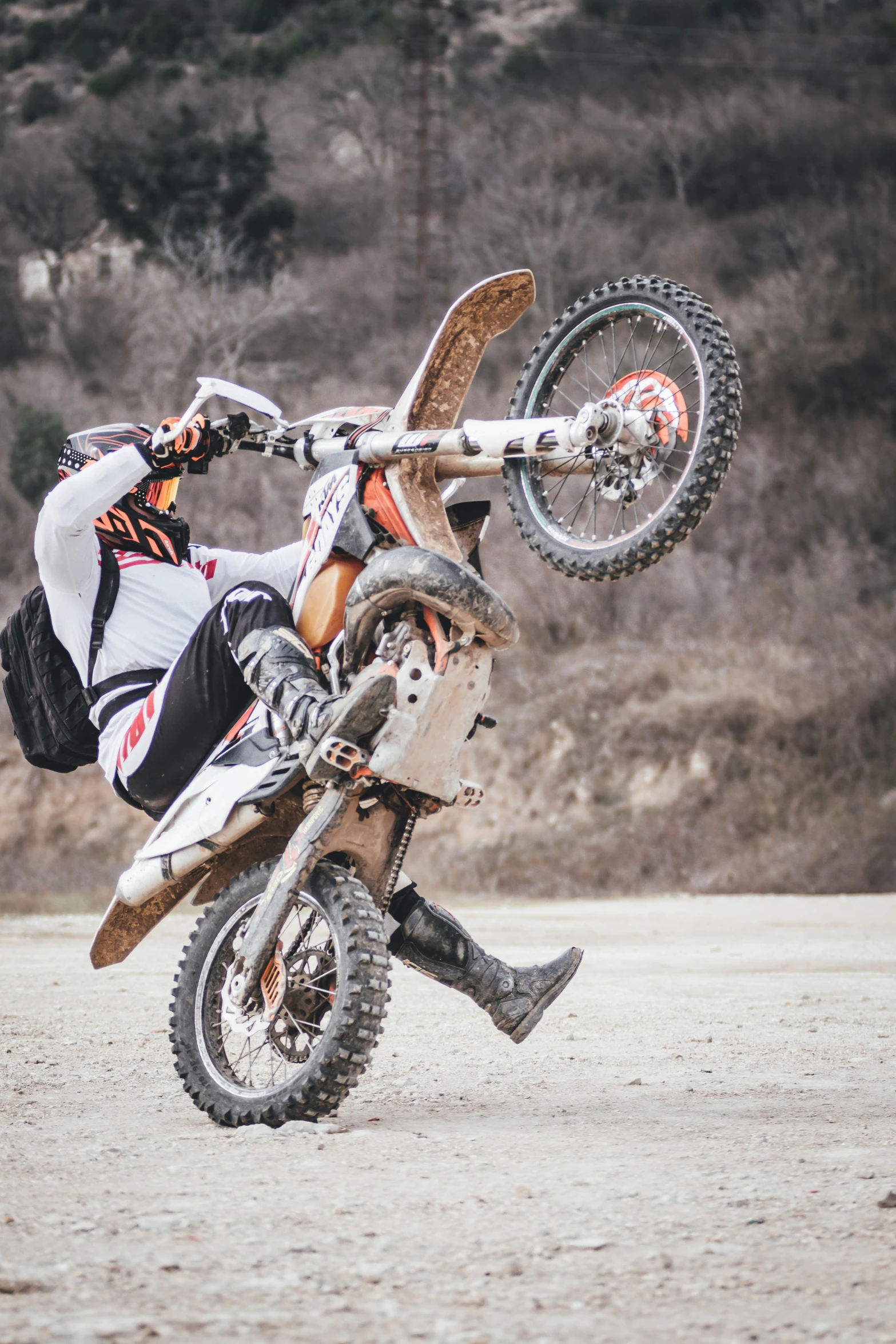 a person doing a trick on a dirt bike, pexels contest winner, doing a sassy pose, orange grey white, white, wheels