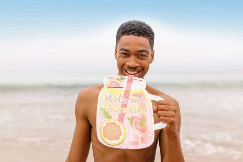 a man standing on top of a beach next to the ocean, an album cover, by Rachel Reckitt, shutterstock contest winner, happening, watering can, cheeky smile, is wearing a swimsuit, juice