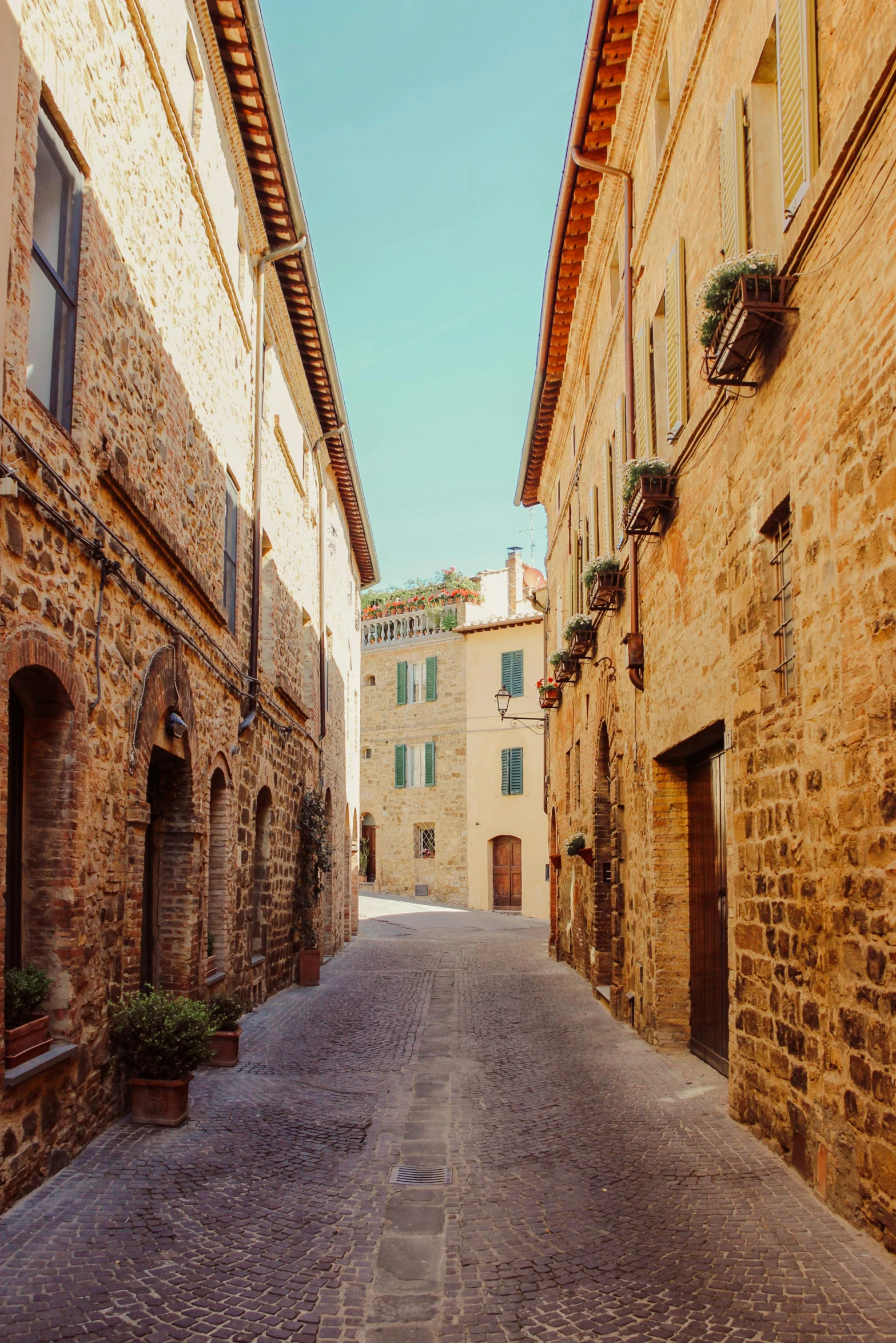 a narrow cobblestone street in an old town, inspired by Vito D'Ancona, pexels contest winner, renaissance, medieval village on the plains, square, slightly sunny, archs and walls