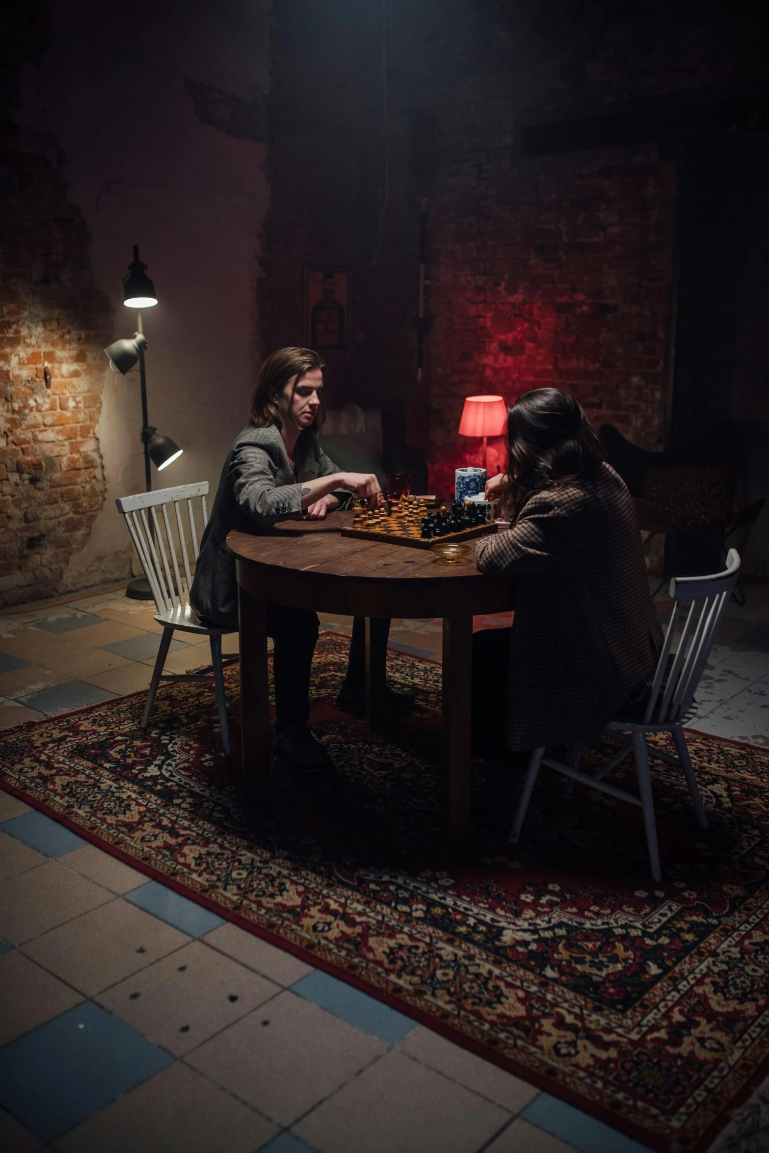 two men sitting at a table playing a game of chess, by Else Alfelt, pexels contest winner, serial art, spooky netflix still shot, soviet apartment, in a dark dungeon, [ theatrical ]