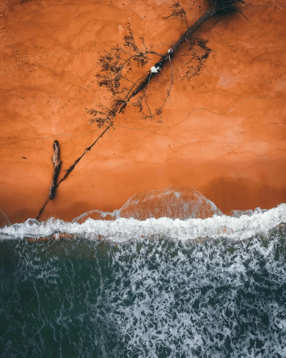 a boat sitting on top of a sandy beach next to the ocean, by Sebastian Spreng, pexels contest winner, aerial iridecent veins, red sand, thumbnail, orange and white