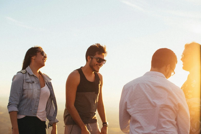 a group of people standing on top of a mountain, by Niko Henrichon, flirting smiling, slight stubble, low sun, profile pic