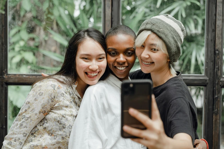 three women taking a selfie in front of a window, trending on pexels, diverse, with a white complexion, avatar image, asian woman