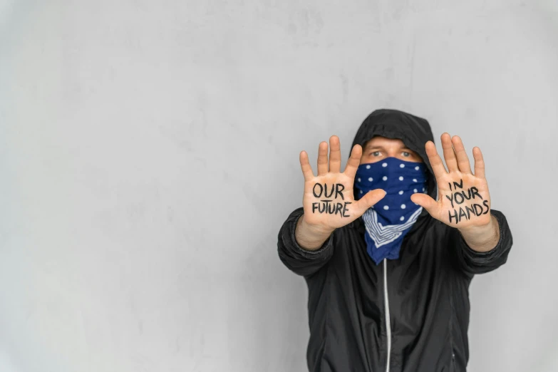 a man wearing a bandana covering his face with his hands, unsplash, graffiti, navy, optimistic future, avatar image, protest