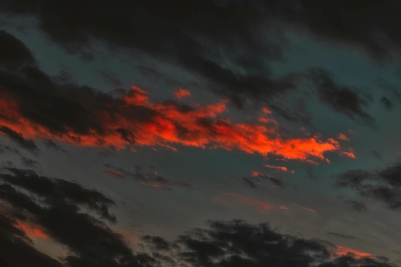 a plane flying through a cloudy sky at sunset, inspired by Elsa Bleda, pexels contest winner, red and obsidian neon, red on black, fire from sky, late summer evening