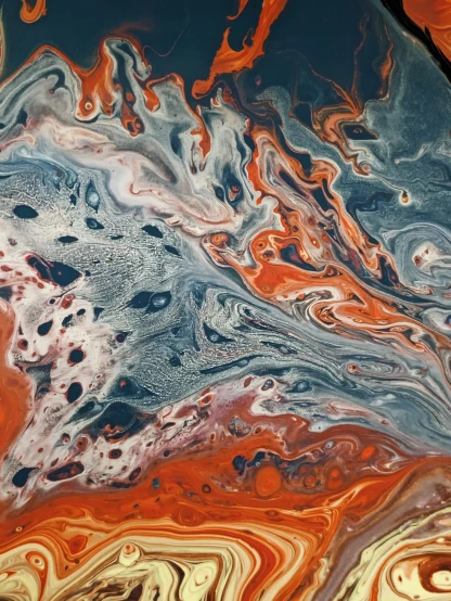 a close up of a piece of art on a table, by Mandy Jurgens, reddit, metaphysical painting, pour paint, dark blue + dark orange, white lava, ilustration