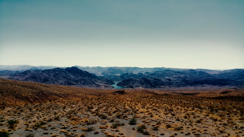 a view of the mountains from the top of a hill, by Thomas Carr, unsplash contest winner, tonalism, las vegas, nadav kander, 2000s photo, joel sternfeld