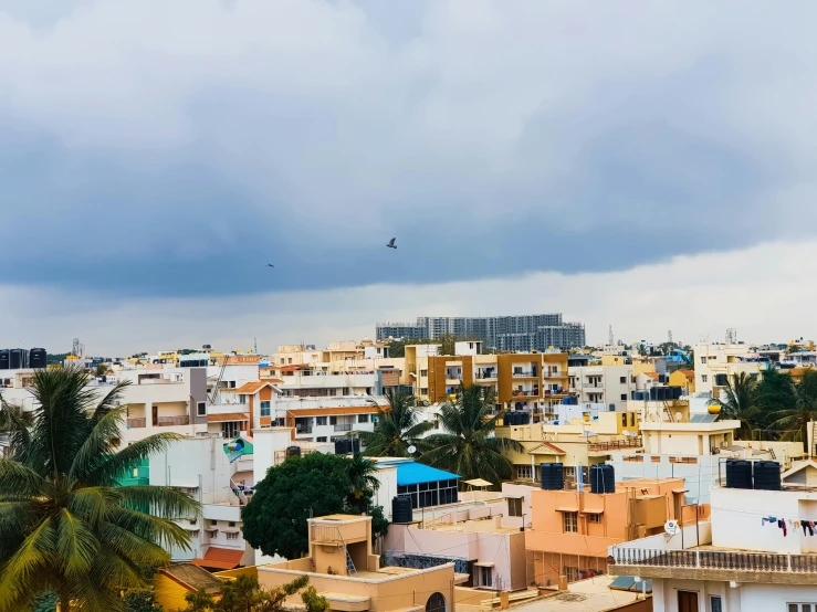 a view of a city from the top of a building, by Max Dauthendey, pexels contest winner, hyperrealism, bangalore, white houses, monsoon on tropical island, skyline view from a rooftop