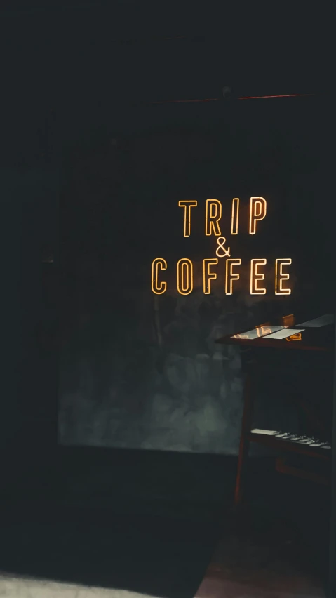 a dark room with a sign that says trip coffee, by Byron Galvez, trending on unsplash, concert, 1 6 x 1 6, 15081959 21121991 01012000 4k, coffee machine