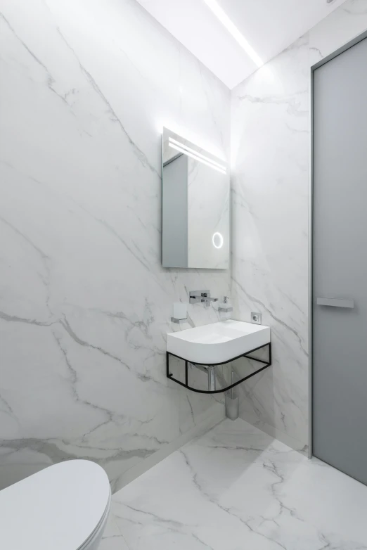 a bath room with a toilet a sink and a mirror, a marble sculpture, inspired by Tommaso Redi, shutterstock, minimalism, square, white marble interior photograph, warsaw, up-angle view