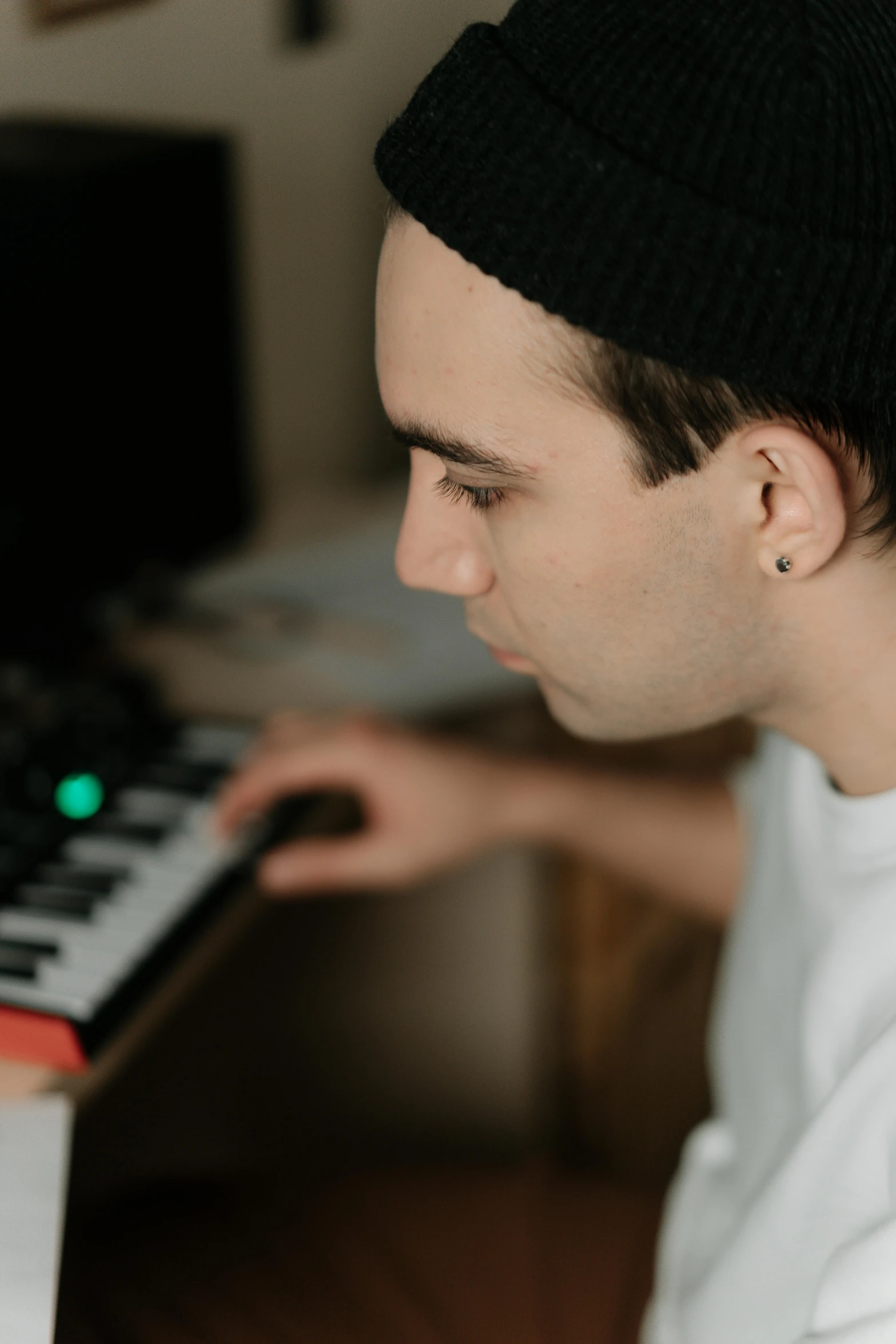 a man that is sitting in front of a keyboard, in a studio, profile pic, slightly smooth, older brother vibes