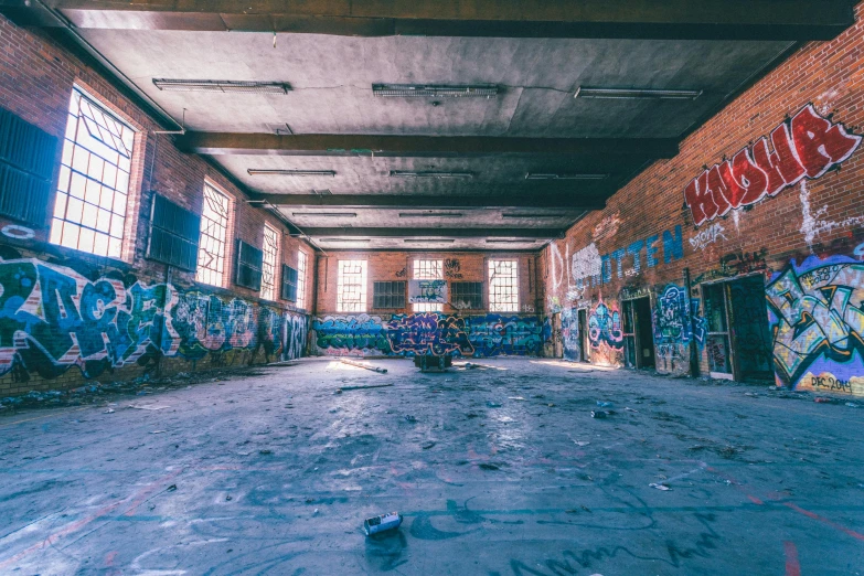 a room with lots of graffiti on the walls, pexels contest winner, vast empty hall, instagram post, demolition, brightly lit blue room