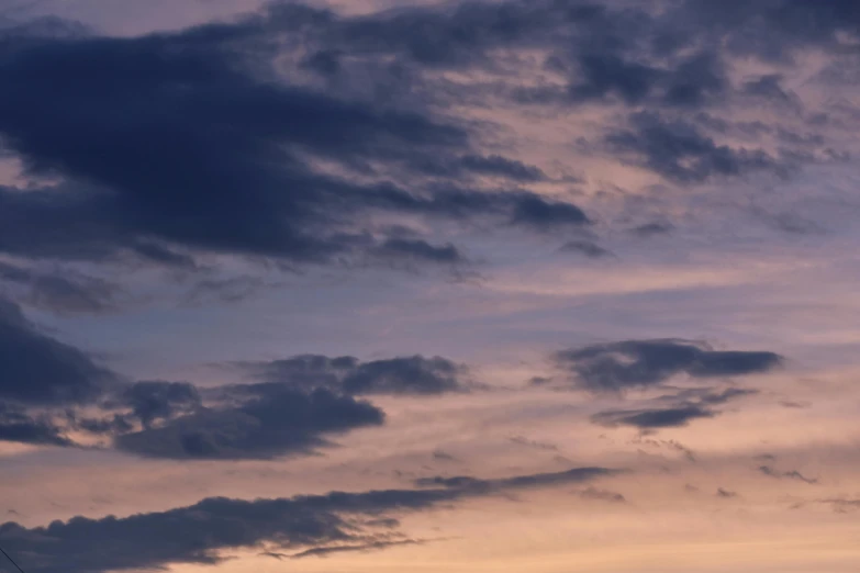 a man flying a kite on top of a lush green field, unsplash, romanticism, dark purple clouds, sunset panorama, layered stratocumulus clouds, night clouds