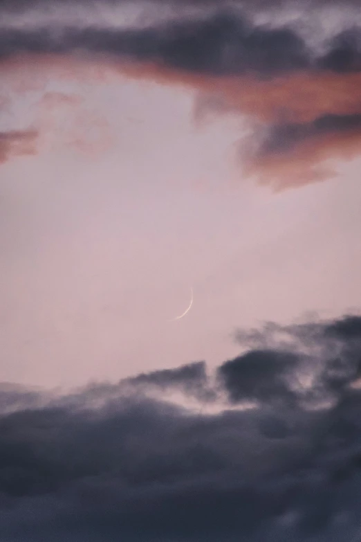 a plane flying through a cloudy sky with the moon in the distance, a picture, inspired by Elsa Bleda, unsplash, aestheticism, pink pastel, crescent moon, sword pointed at sky, color photograph