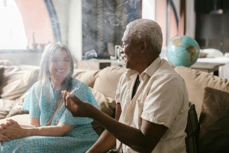 a man and a woman sitting on a couch, pexels contest winner, smoker, joyful people in the house, two aboriginal elders, emanating white smoke