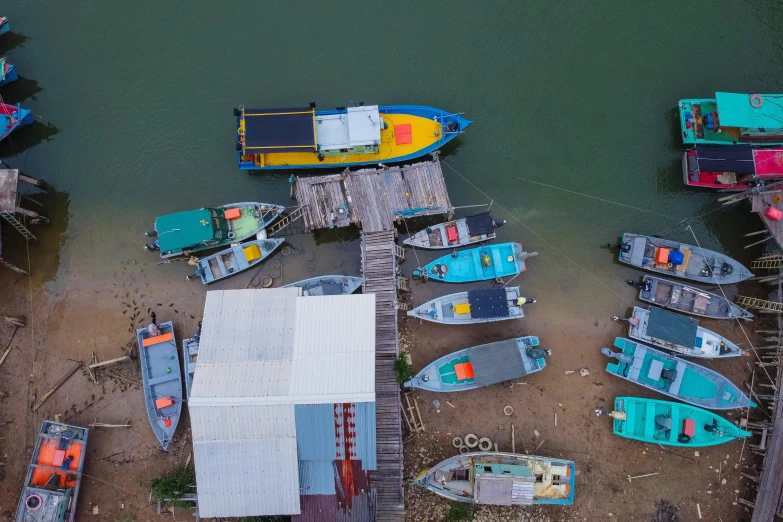 a number of small boats in a body of water, by Daren Bader, pexels contest winner, boat dock, air shot, various colors, lim chuan shin