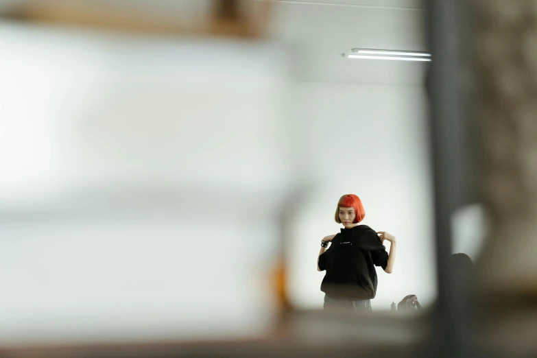 a person taking a picture of themselves in a mirror, pexels contest winner, visual art, black and red hair, office clothes, minimalist photorealist, in a workshop