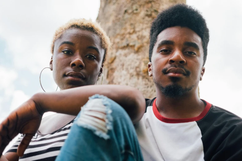 a man and a woman sitting next to each other, a portrait, trending on unsplash, afrofuturism, teenage boy, beautiful male twins portrait, 15081959 21121991 01012000 4k, short blonde afro