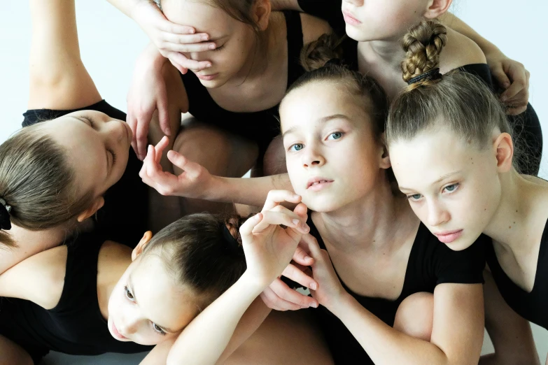 a group of young girls sitting on top of each other, an album cover, by Elizabeth Durack, shutterstock, antipodeans, ballet pose, sad face, 15081959 21121991 01012000 4k, high angle close up shot