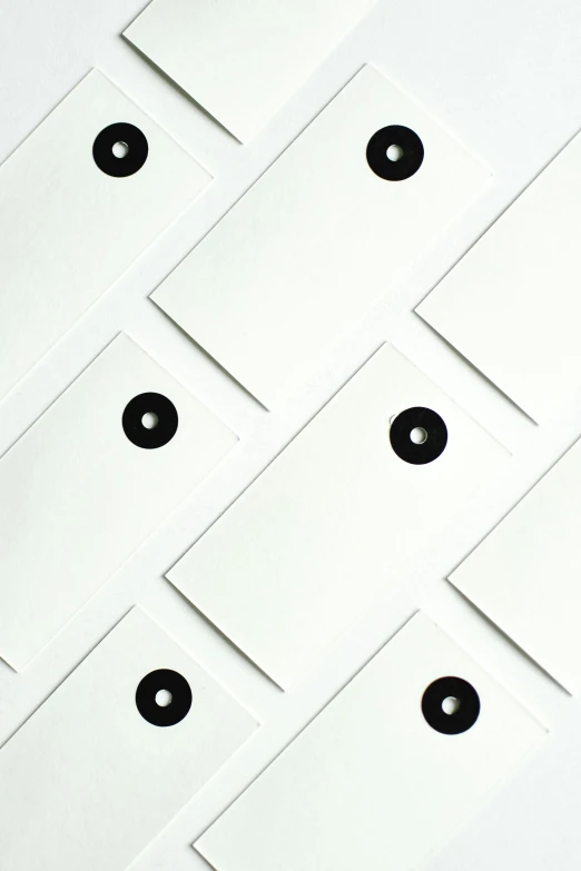 a bunch of white envelopes sitting on top of a table, an album cover, unsplash, letterism, square black pupil centered, bolts, close-up shot taken from behind, white-space-surrounding