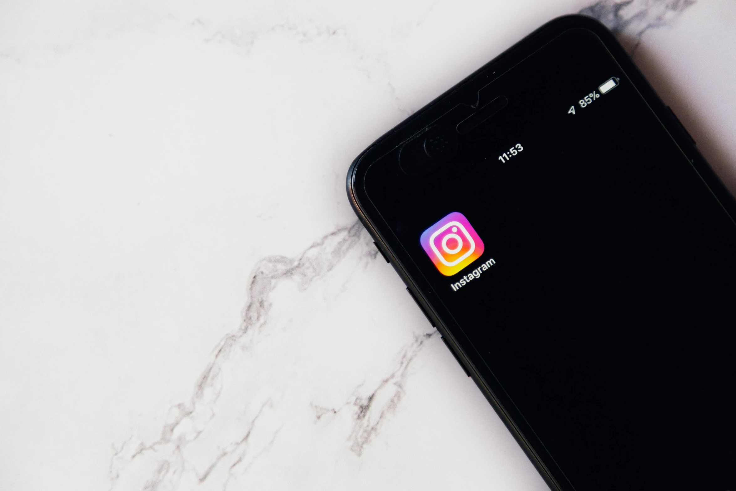 a close up of a cell phone on a marble surface, trending on instagram, dating app icon, dark-skinned, digital screenshot, on a white table