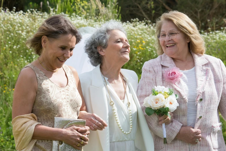 a group of women standing next to each other, a picture, by Ruth Abrahams, unsplash, silver，ivory, in the garden, giggling, from left