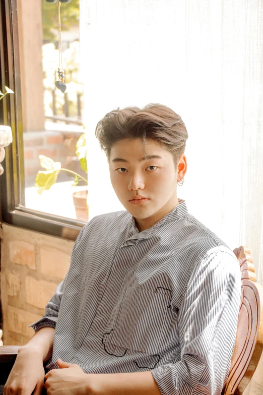 a man sitting at a table with a plate of food, an album cover, inspired by Joong Keun Lee, unsplash, renaissance, young adorable korean face, bbwchan, medium portrait soft light, androgynous person