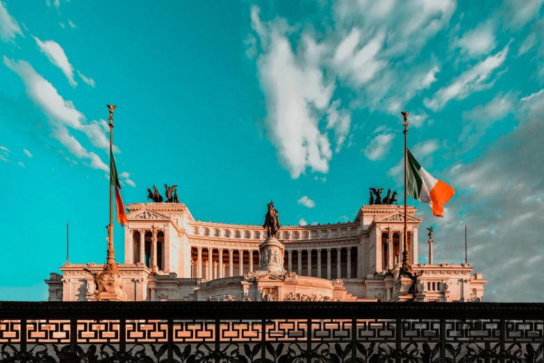 a large building with many flags on top of it, pexels contest winner, neoclassicism, rome in background, avatar image, frontal picture, teal and orange colours