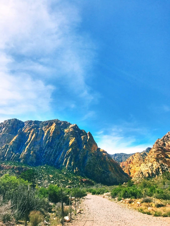 a dirt road with mountains in the background, at the top of a red rock canyon, instagram picture, official screenshot