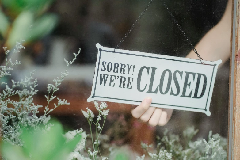 a person holding a sign that says sorry we're closed, pexels, happening, 👰 🏇 ❌ 🍃, window open, etsy, restoration